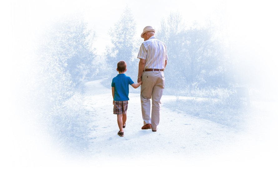 Older gentleman holding hands and walking with his son, indicating restored mobility of the hip and/or knee.