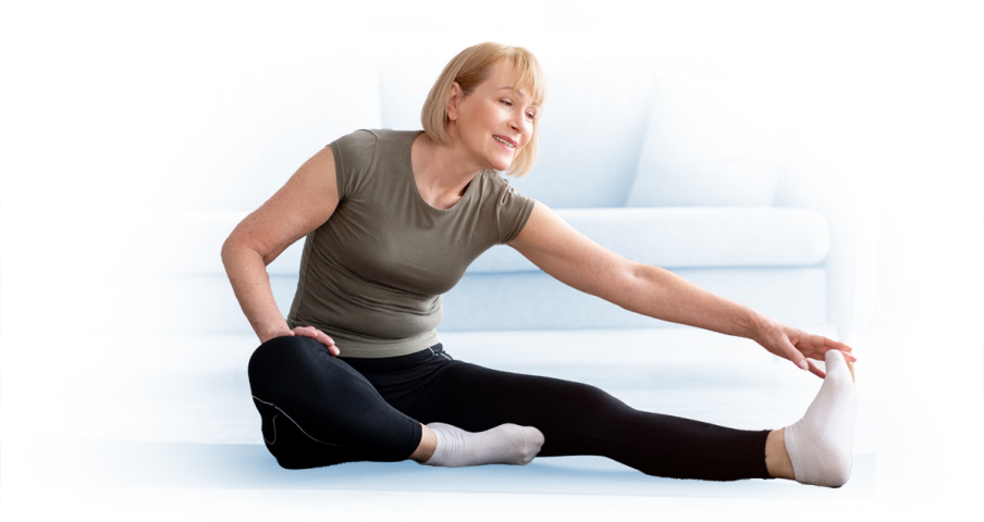 Older woman stretching, indicating restored mobility of the hip